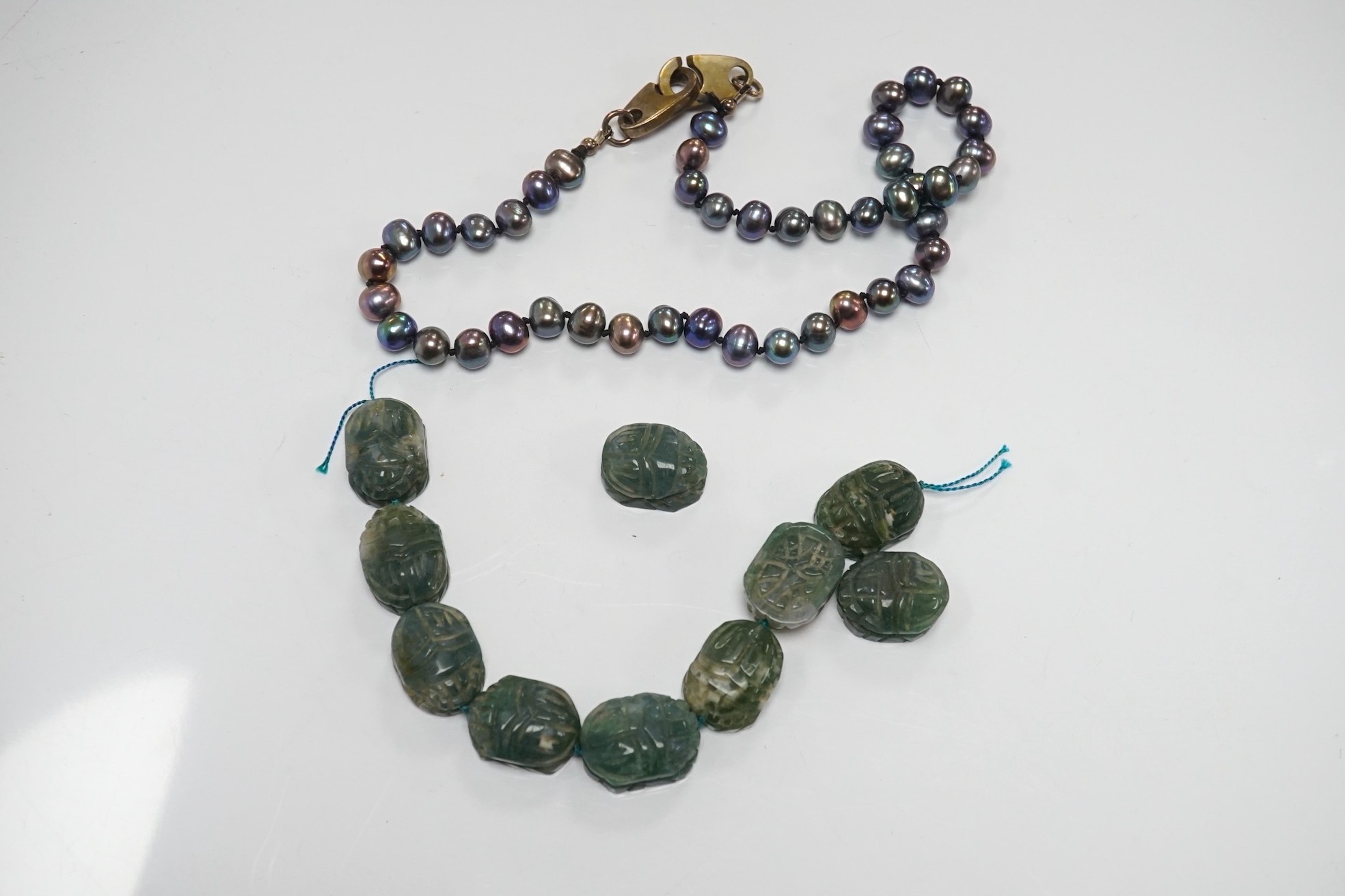 A large collection of bead necklaces and unmounted turquoise and baroque pearls. Condition - fair